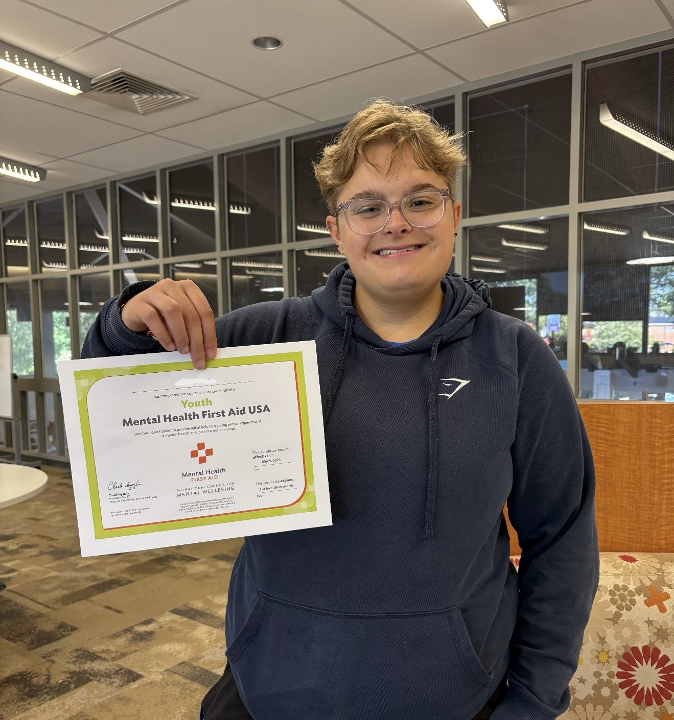 Student holding a certificate.