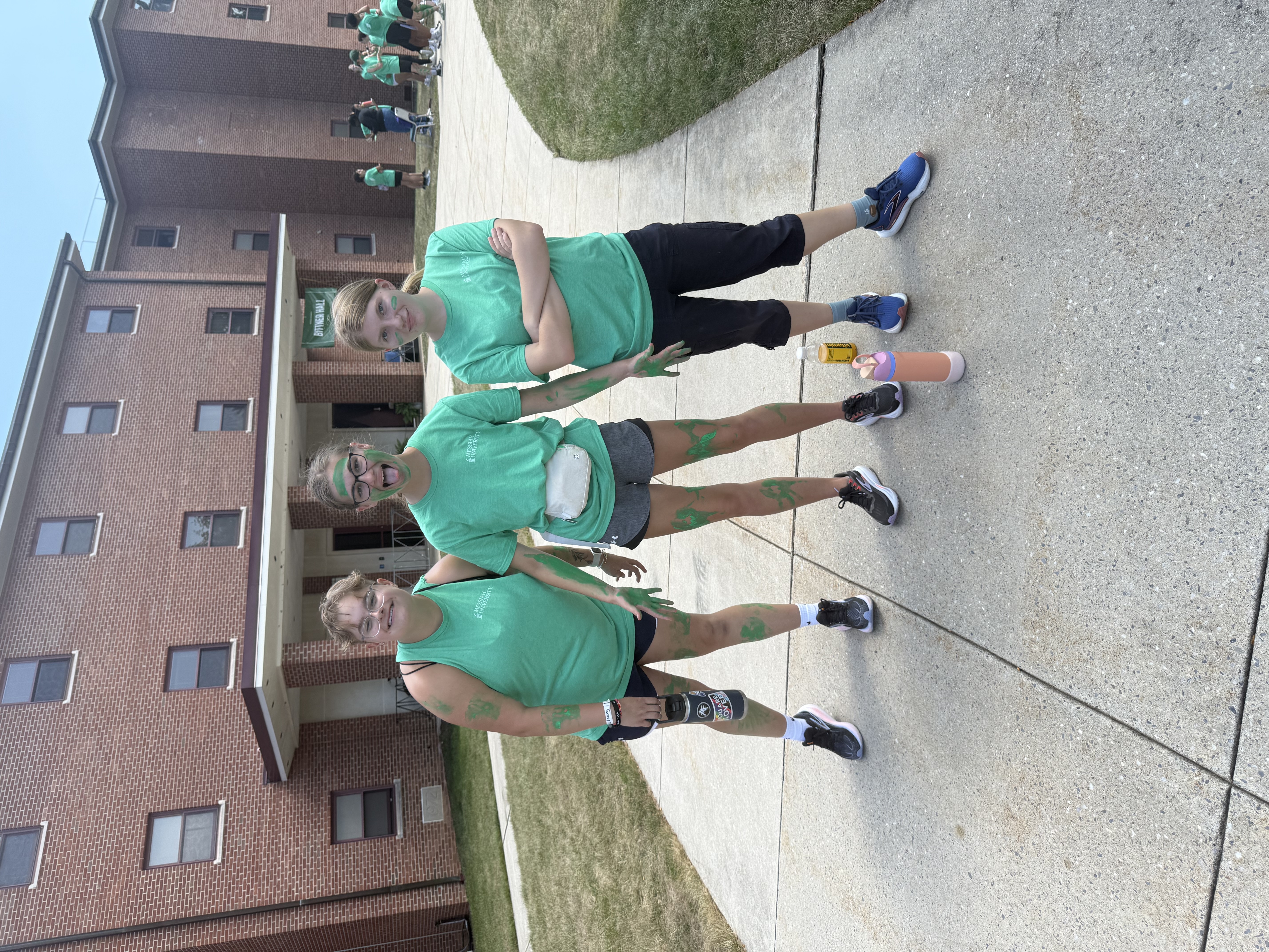 Students with green body paint at first year games.