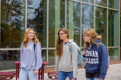Three girls walking and talking