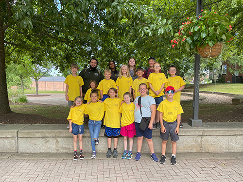 Group photo of children in yellow curator club t-shirts
