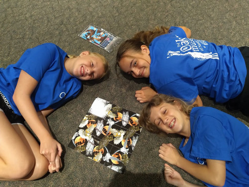 Girls next to a completed owl puzzle