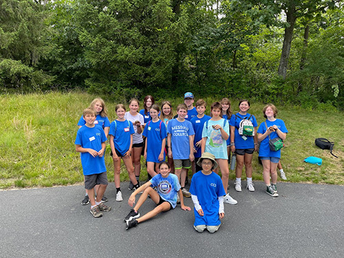 Group photo of children in blue cc2 t-shirts