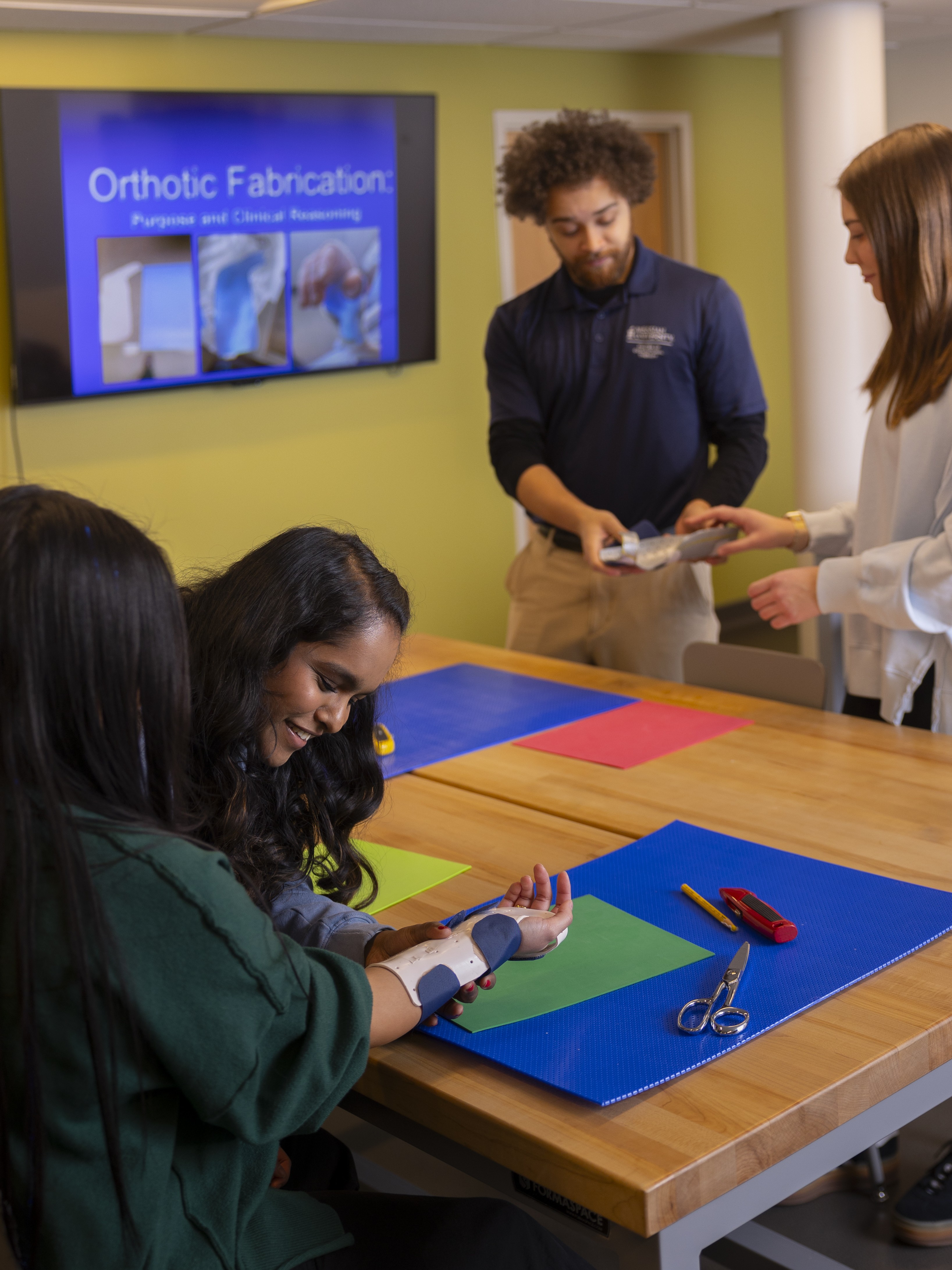 Four students work to create and fit custom splints