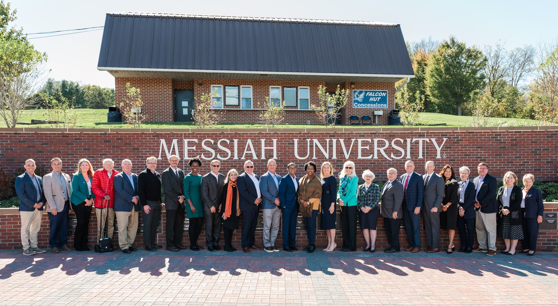 Board of Trustee group photo in front of Messiah sign at Lenhert Plaza