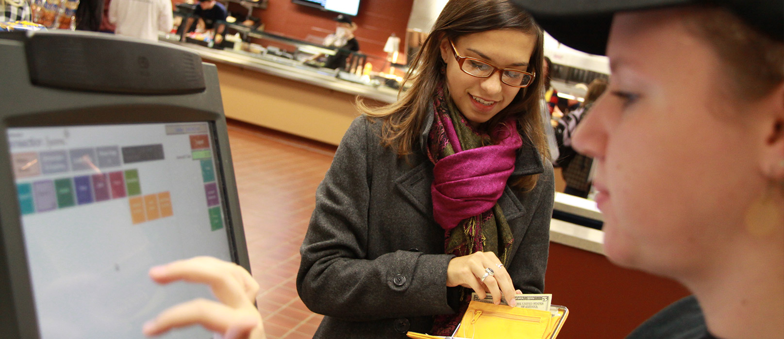 Purchasing Cards A customer paying the cashier at the falcon.jpg