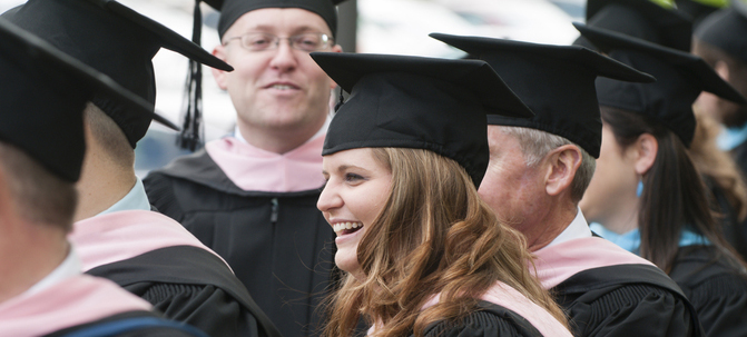 Graduate Programs graduates wearing their caps and gowns.jpg