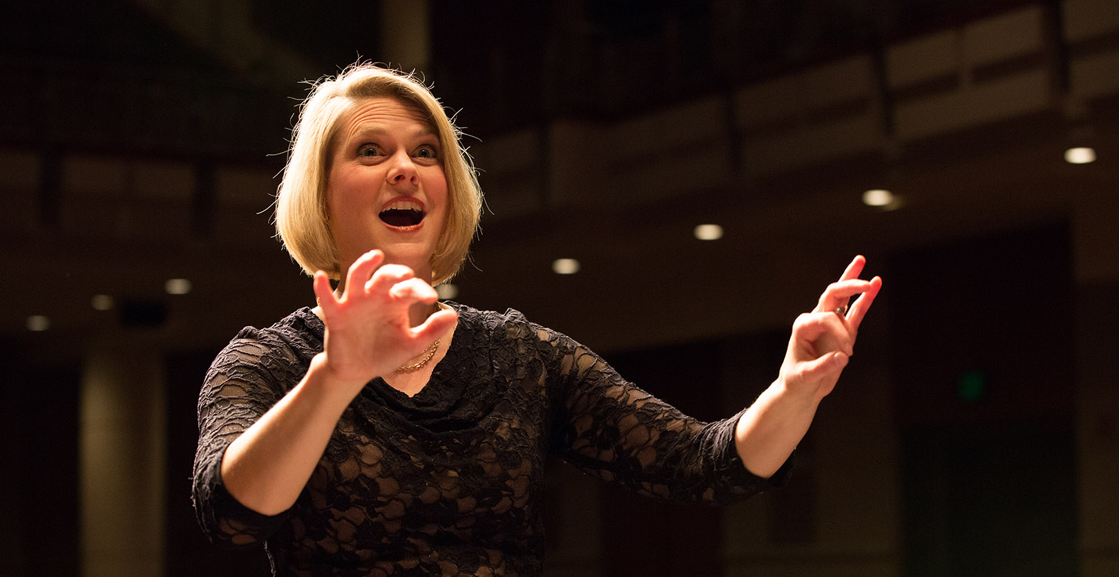 Graduate Programs: Music A female conductor actively conducting a musical piece.jpg