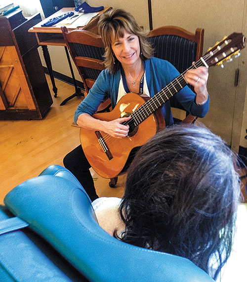 Lori Nowaczyk playing guitar