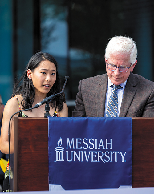 Student Jadyn Jeffers 23 (left) and new BOT chair Craig Sider speak to the crowd