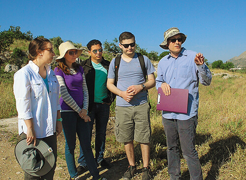 David Pettegrew, professor of history and archaeology, and students do field work