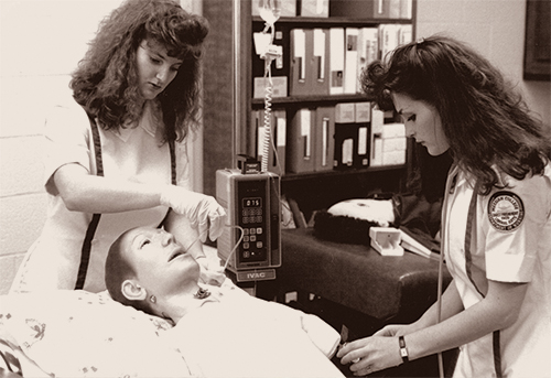 An old, sepia tuned photo of two nursing students