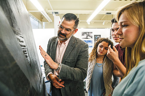 Messiah College Professor and students looking at artwork
