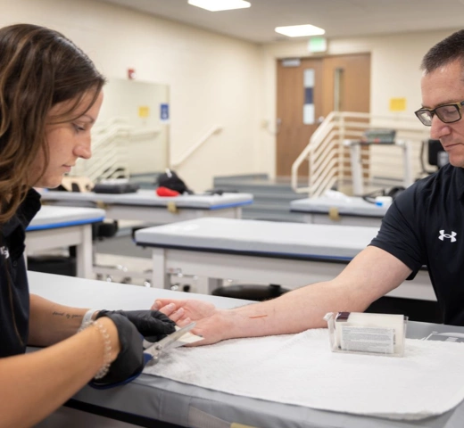Students bandaging up students in athletics
