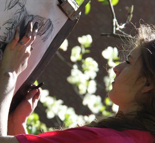 student doing art with chalk 