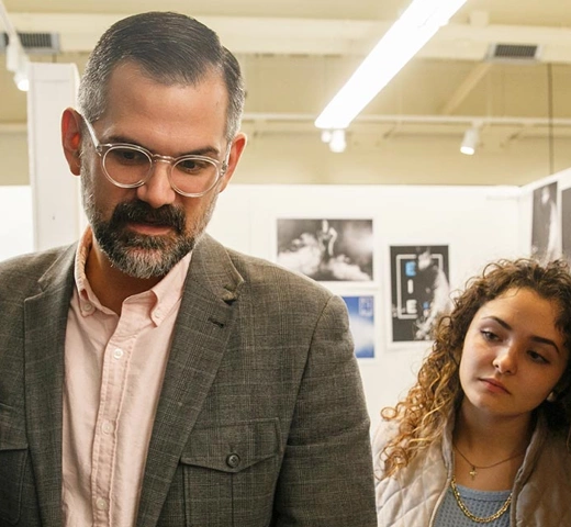 Professor and student discussing art piece