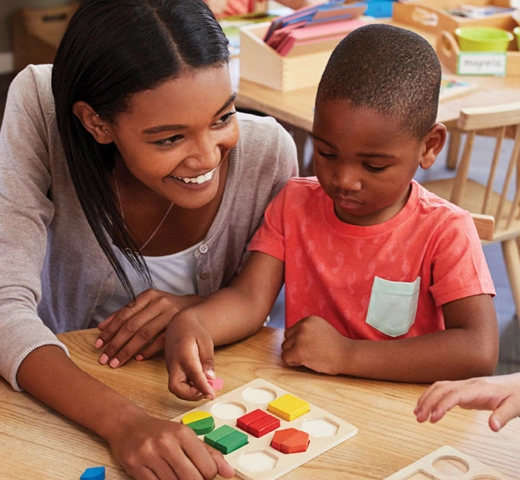 Female student teacher with three children in a kindergarten setting