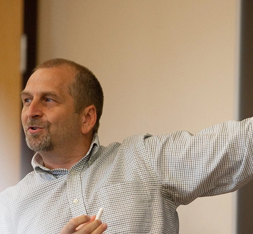 Male professor standing at chalk board