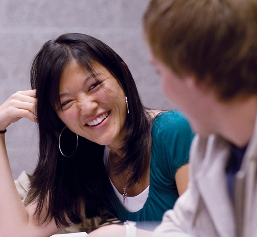 students talking to each other in a classroom