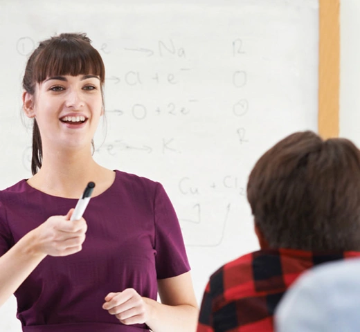 teacher pointing to a student in a classroom