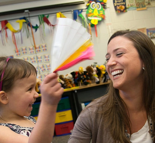playing with a child in a classroom