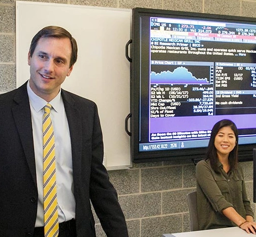 professor and class looking at the stock market