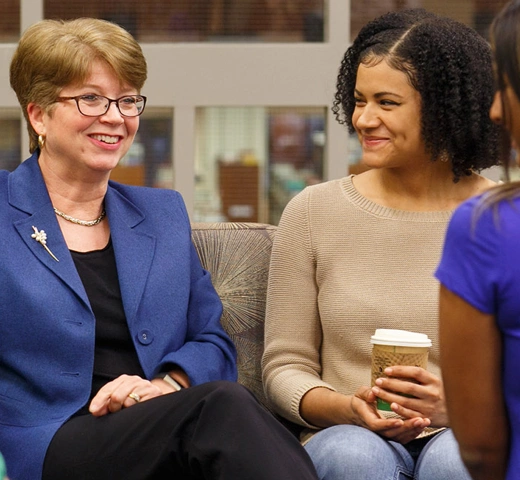 Professor Raeann R. Hamon and three students in discussion