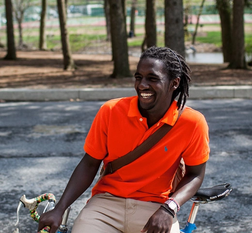 students talking in a park on a bike