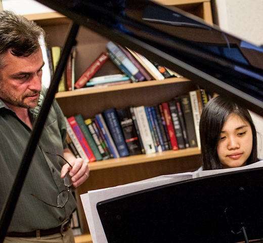 Professor and student at a piano