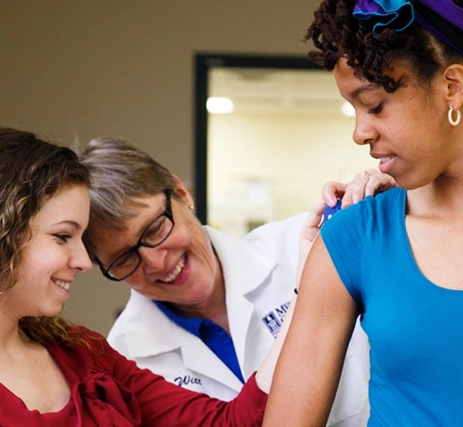 student and medical professor measuring an arm