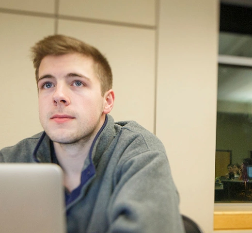 Students in class with a MacBooks