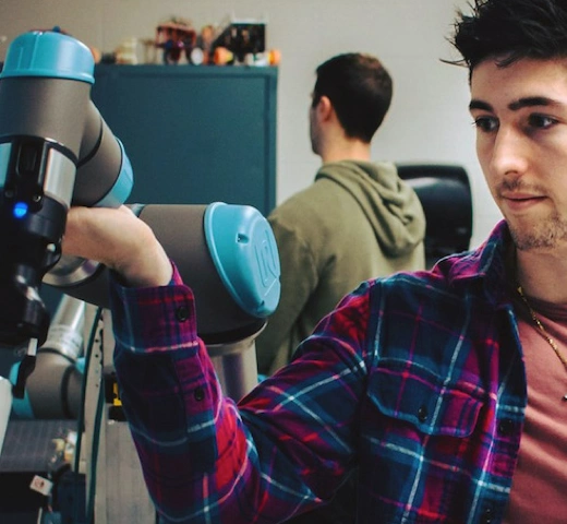 Male engineering student working on a robot