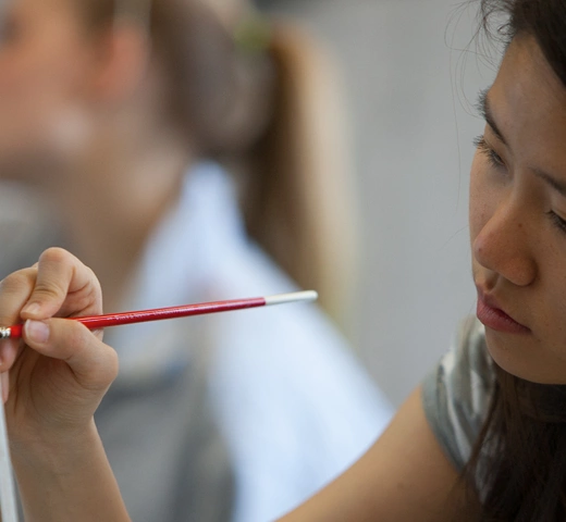 Student drawing on a canvas