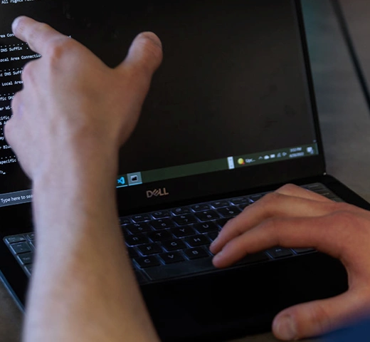 students coding on a laptop