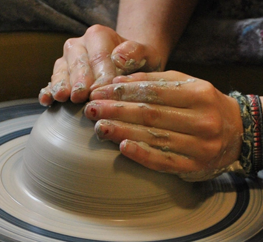 working with pottery on a spin wheel 