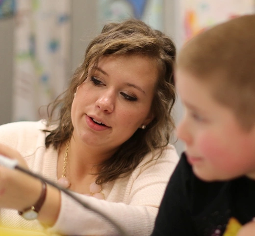 Student teaching young student art