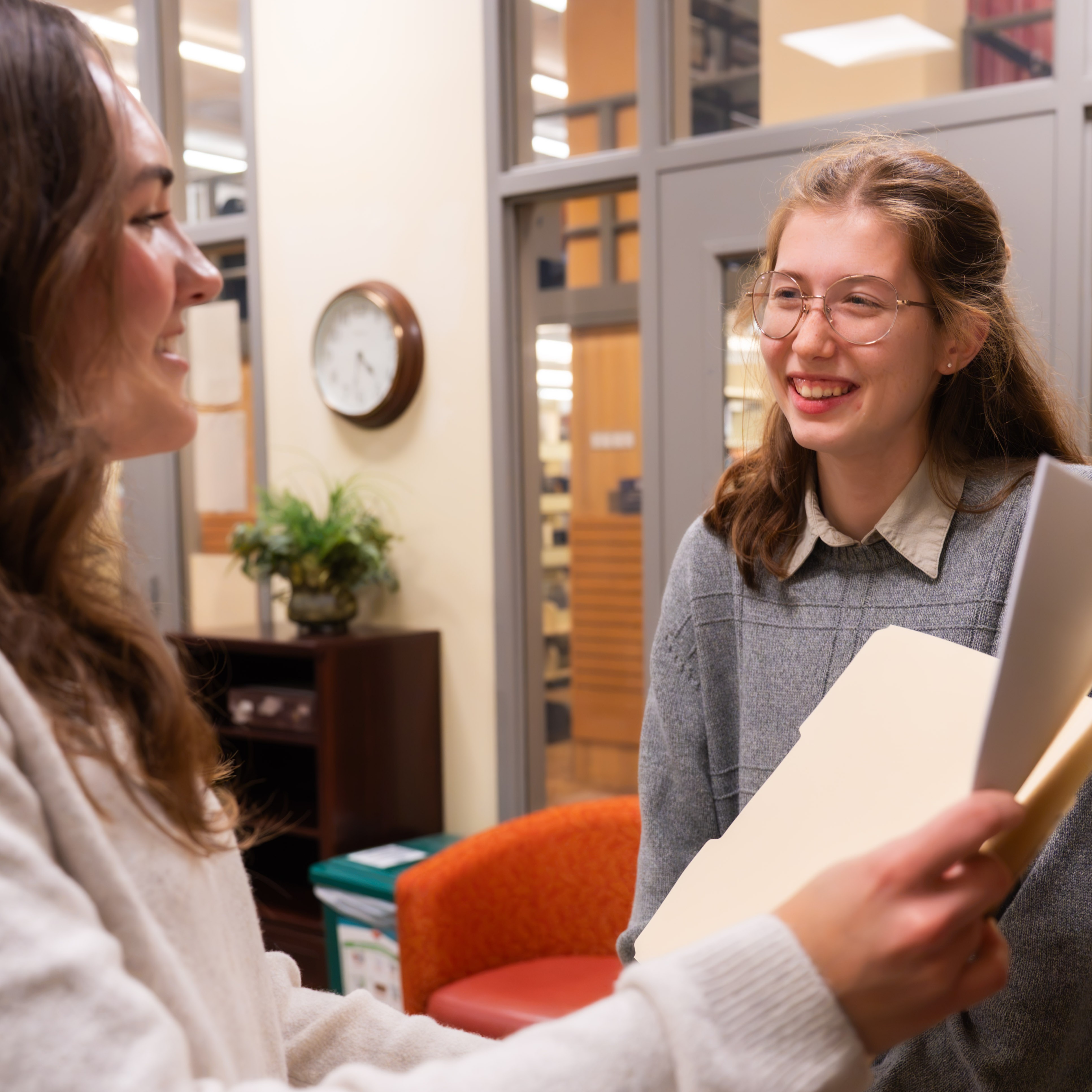 Writing Center tutor greets client.